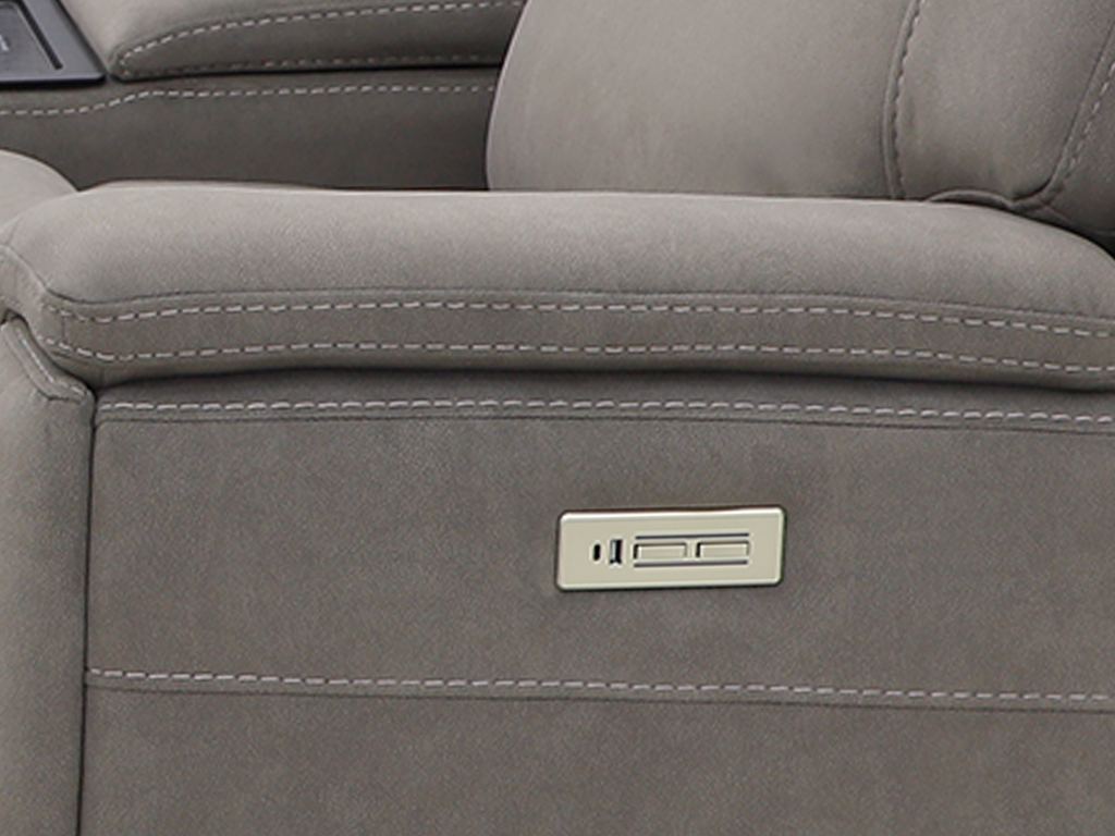 The sectional's gray fabric arm with a brushed-metal control panel set flush into it.