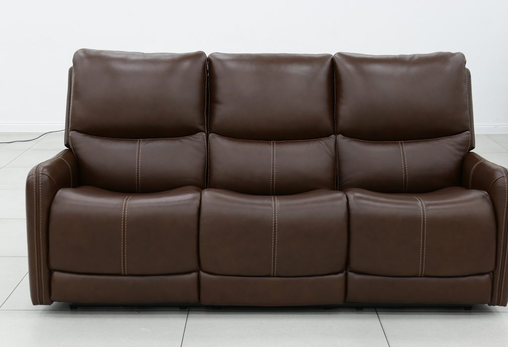 Three-seat brown leather power reclining sofa with contrast topstitching.