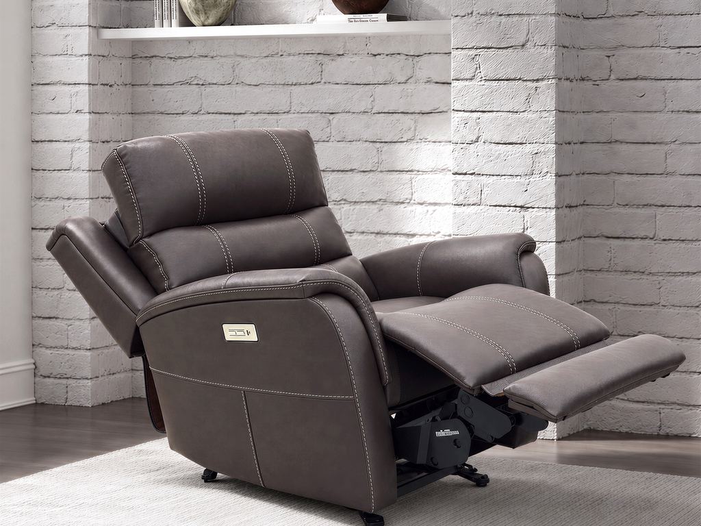 The dark brown leather recliner fully reclined, footrest raised.