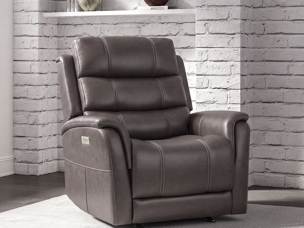 A dark brown leather power recliner beside a white brick wall with a floating shelf.