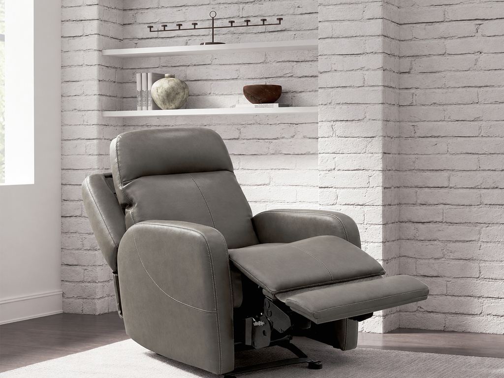 The gray leather recliner fully reclined, footrest raised.