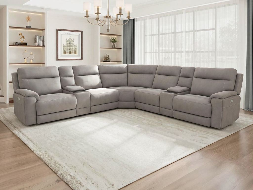 A gray fabric power reclining sectional in an L-shape, with two storage consoles and a corner wedge seat, in a sunlit living room.