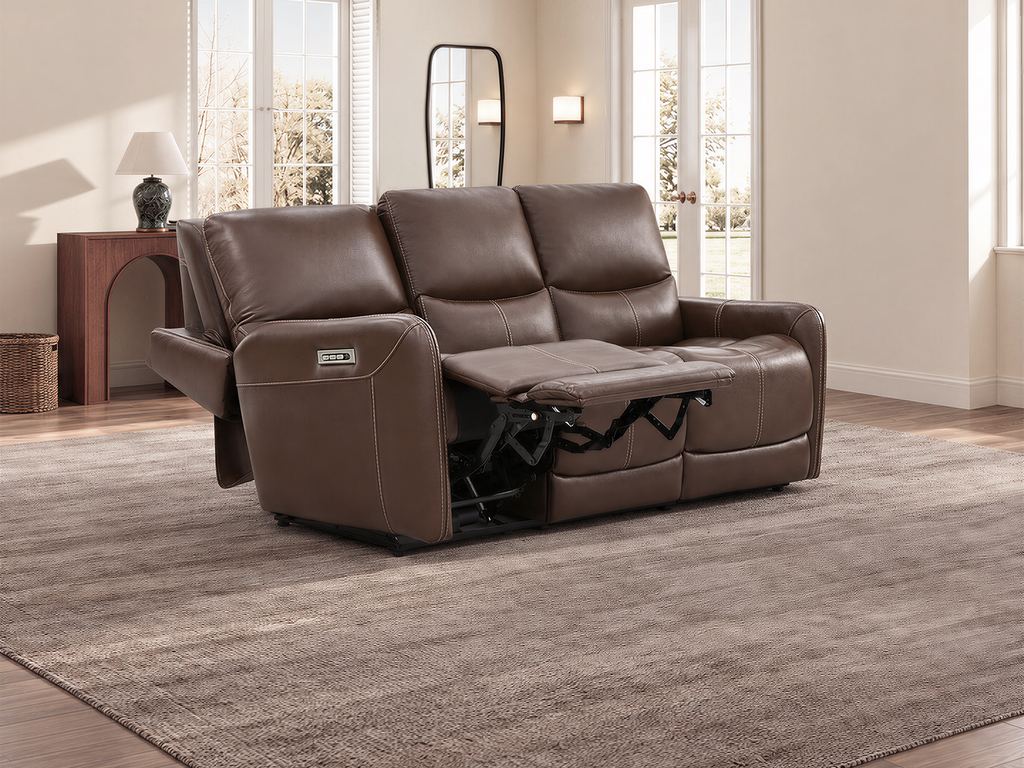 The same brown leather sofa with one end seat fully reclined and its footrest raised.